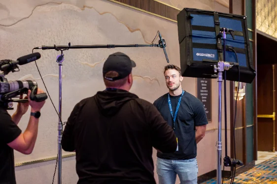 Creator being interviewed on camera at a Military Creator event
